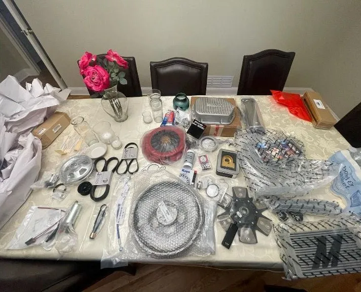 Car parts laid out on a table ahead of the tune, including a clutch and flywheel