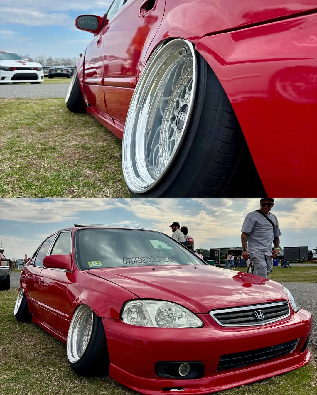A lowered red Honda Civic sedan on polished wheels
